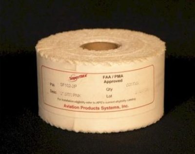 A roll of toilet paper with a label indicating FAA/PMA approval from Aviation Products Systems, Inc. The label includes product details and a lot number, set against a dark background.