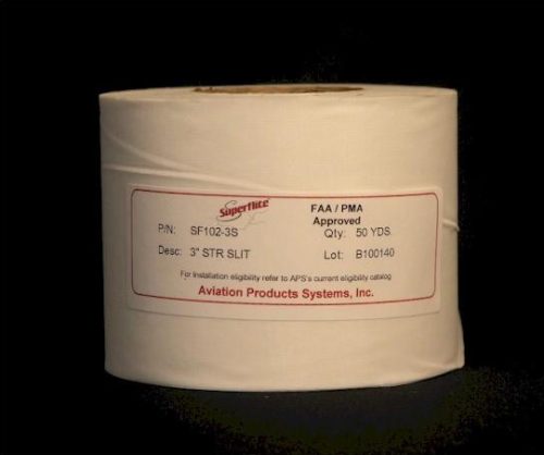 A large roll of white material labeled with "Aviation Products Systems, Inc." and details like part number, quantity, and lot number. The label is red and centered on the roll. The background is black.