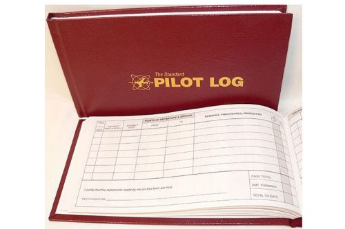 Red pilot logbook with gold lettering on the cover, open to show lined pages for recording flight details.