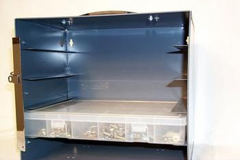 Open blue metal storage cabinet with multiple shelves and a transparent plastic organizer containing small items at the bottom. The cabinet is on a white background.