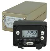 A Flight Line FL-760 radio panel displaying frequencies 136.9750 and 108.0000. It features knobs for on/off, volume, and frequency adjustments, with buttons labeled EMG, PRI, MOD, and an arrow indicating navigation.