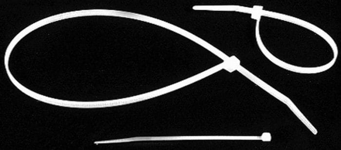 Three white cable ties on a black background, with two looped and one straight.