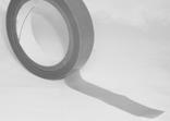A roll of duct tape with a portion unrolled, lying on a flat surface. The tape is gray and casts a shadow on the surface.