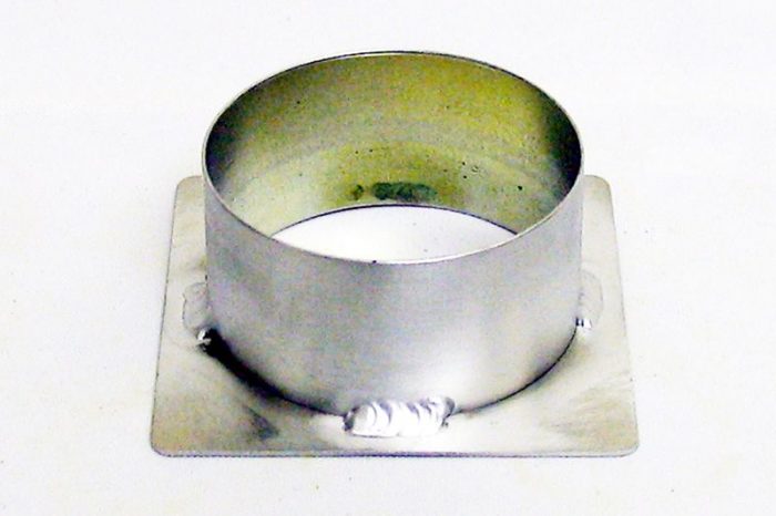 A cylindrical metal duct adapter with a square base, featuring weld marks at the base, set against a plain white background.