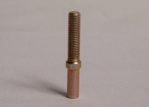 A metal bolt with a threaded top and a smooth lower section stands upright on a plain surface.