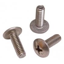 Three silver Phillips head machine screws on a white background, with one upright and two lying flat.