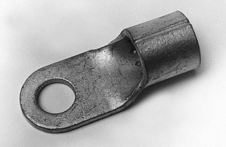 Metal lug terminal with a cylindrical end and a flat tab featuring a circular hole, used for electrical connections, on a plain background.