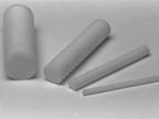 Four cylindrical chalk pieces of varying lengths are placed on a flat surface. The chalks are white and arranged in a slightly scattered manner.
