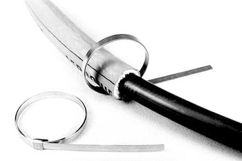 A metal hose clamp is shown securing a black hose. Another loose clamp lies nearby. The clamps are silver with a tightening mechanism, designed for fastening hoses or pipes.