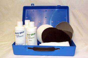 Open blue case containing bottles labeled "Micro-Gloss," polishing pads, and cloths.