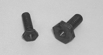Two black hex head screws of different sizes are placed on a light gray surface. The larger screw is on the right, and both have pointed tips.