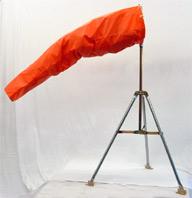 Orange windsock mounted on a tripod stand against a plain white background.