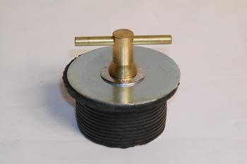 A brass test plug with a T-handle on top and a rubber gasket around the threaded body.